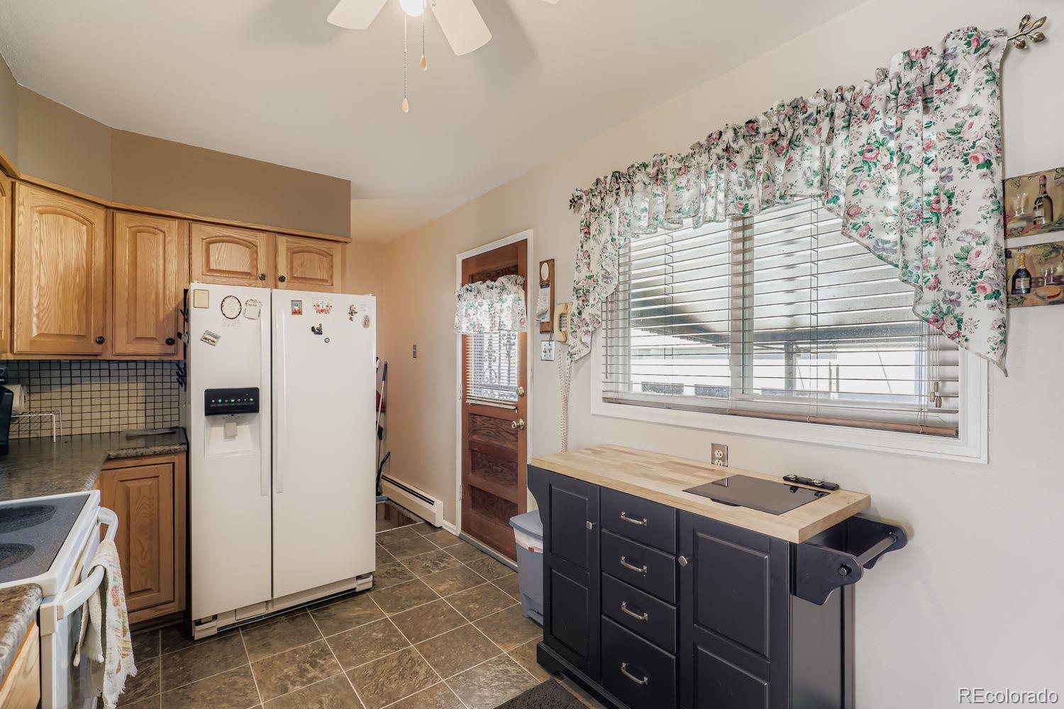 5441 East 67th Place Commerce City, CO 80022 - Photo 10 of 19 a kitchen with a refrigerator and a sink
