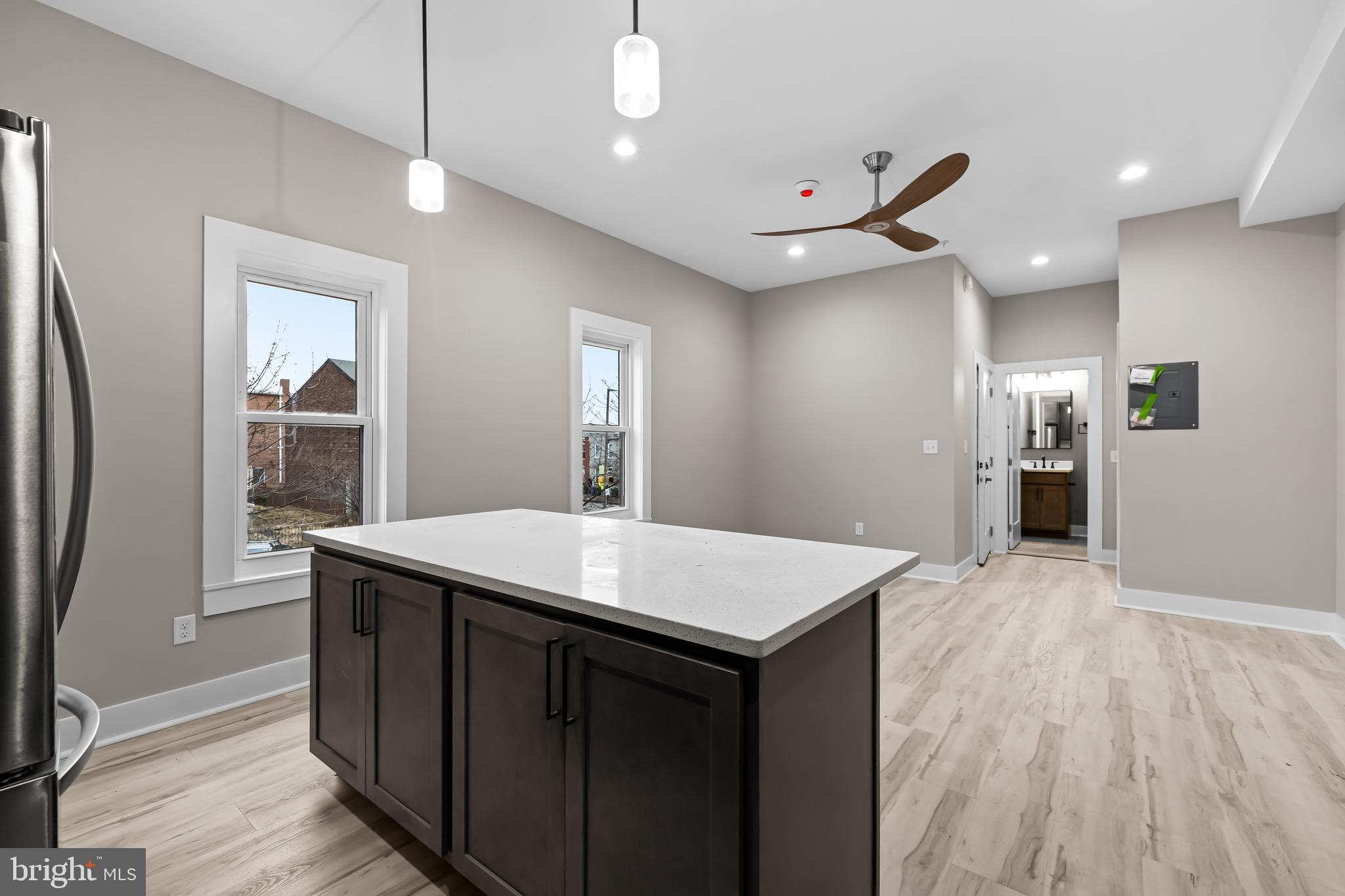 400 South Conkling Street, Unit 2 Baltimore, MD 21224 - Photo 11 of 17 a kitchen with kitchen island a sink stove and refrigerator