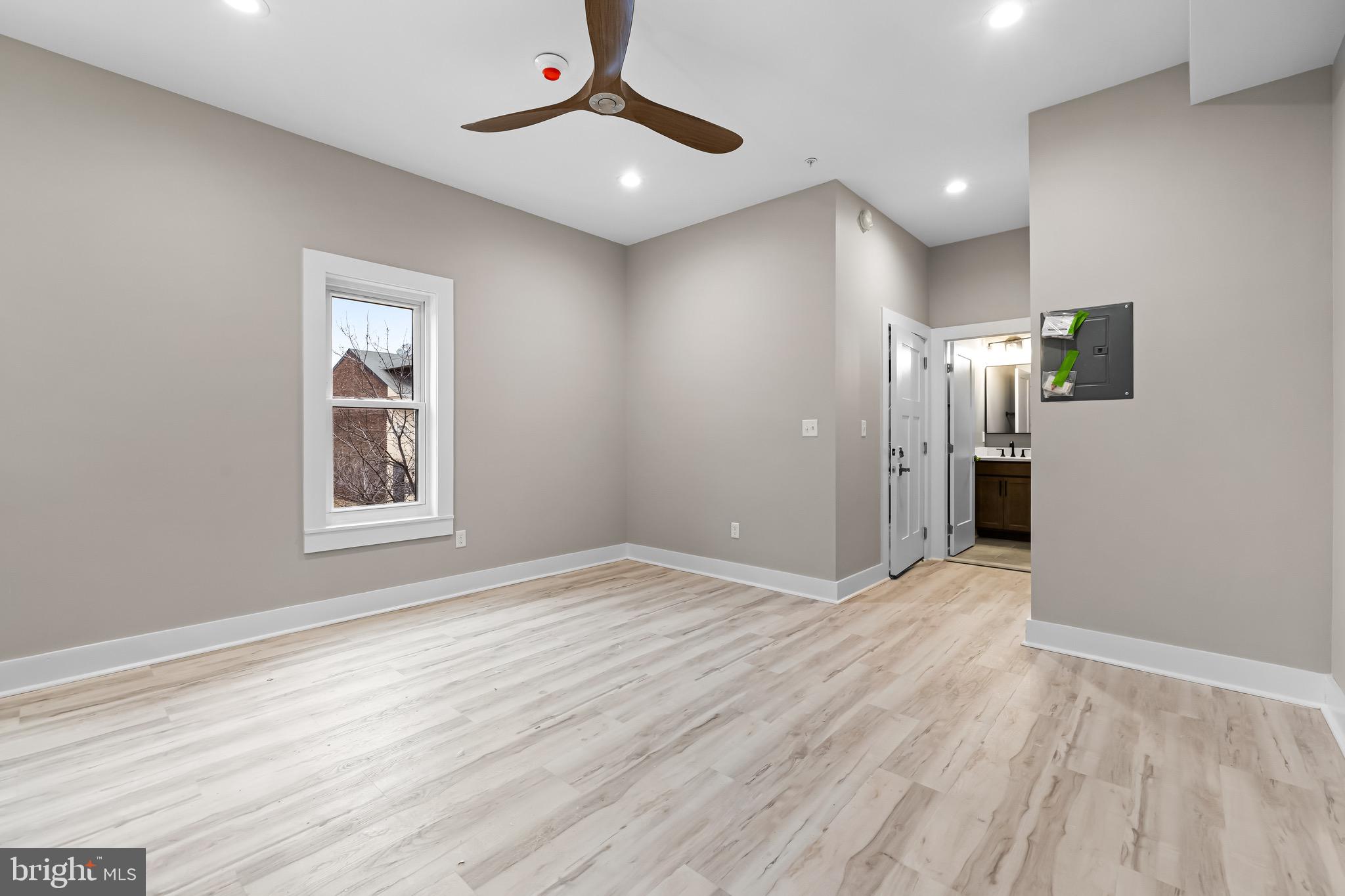 400 South Conkling Street, Unit 2 Baltimore, MD 21224 - Photo 12 of 17 wooden floor in an empty room with a window