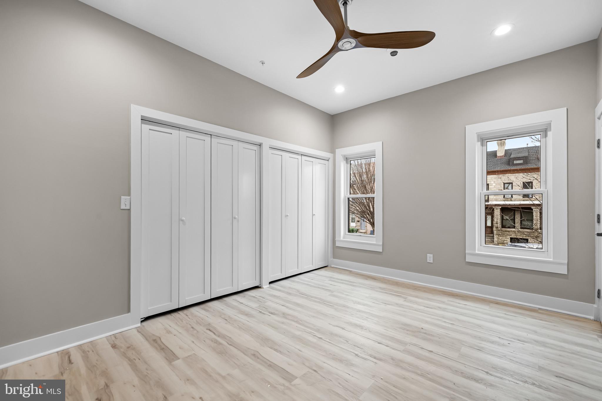 400 South Conkling Street, Unit 2 Baltimore, MD 21224 - Photo 14 of 17 an empty room with wooden floor cabinet and windows