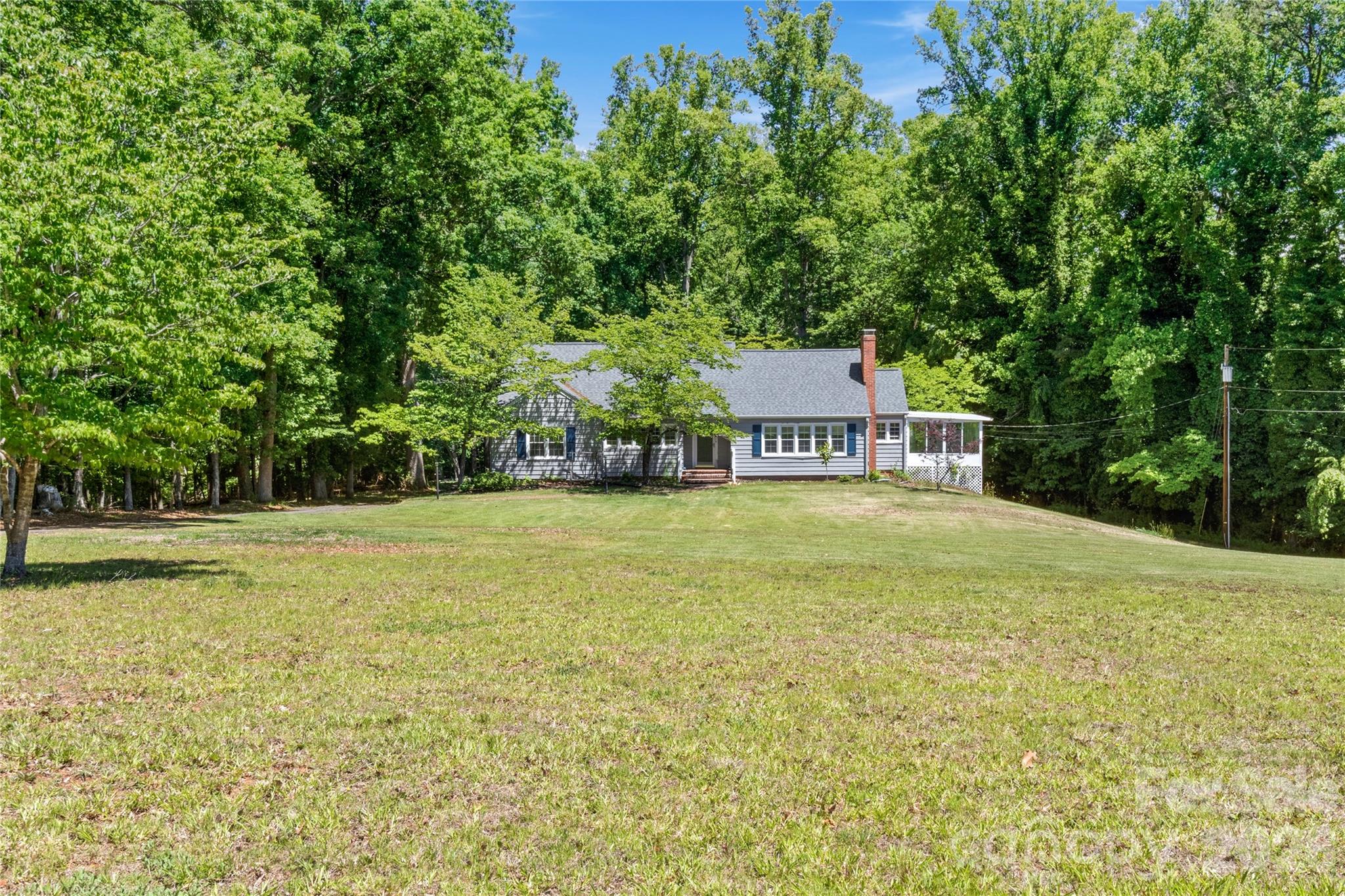 951 Dodson Mill Road Pilot Mountain, NC 27041 - Photo 3 of 48 a house view with a trees in the background