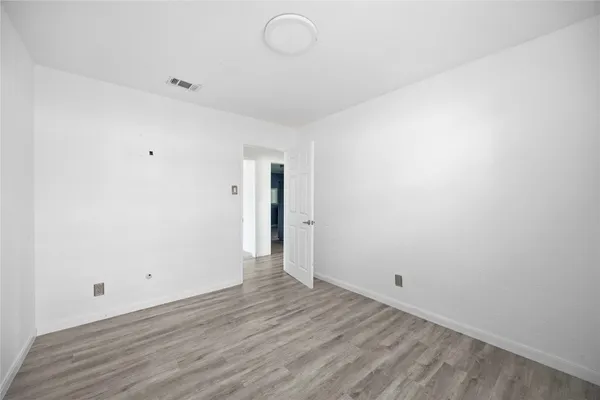a view of room with wooden floor