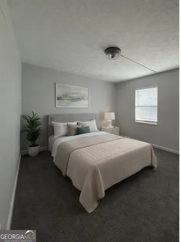 a bedroom with a bed and window