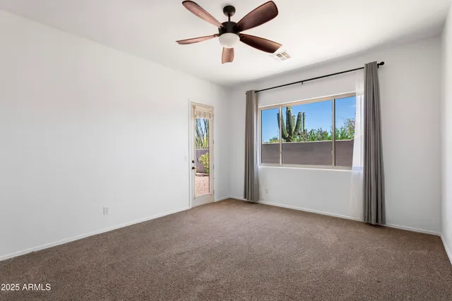 a view of room with window and ceiling fan