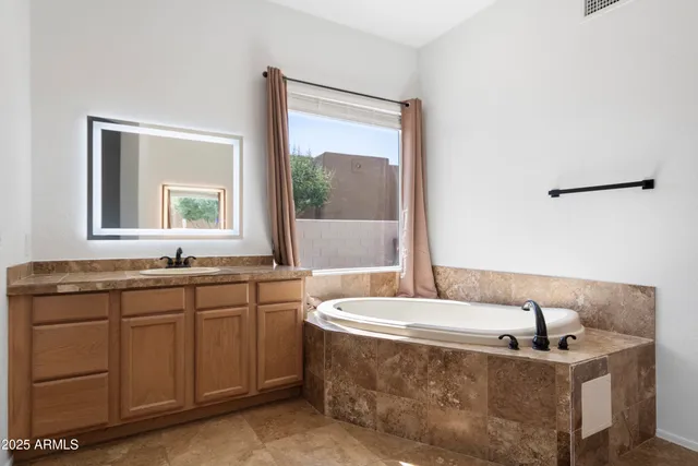a bath tub sitting in a bathroom next to a window
