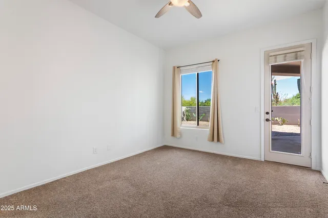 an empty room with windows and closet
