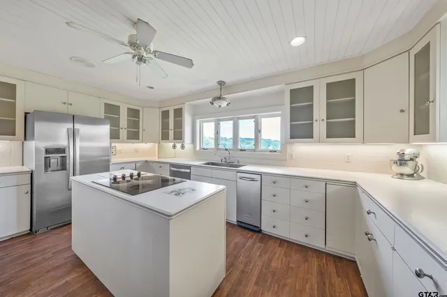 a kitchen with a refrigerator and a sink