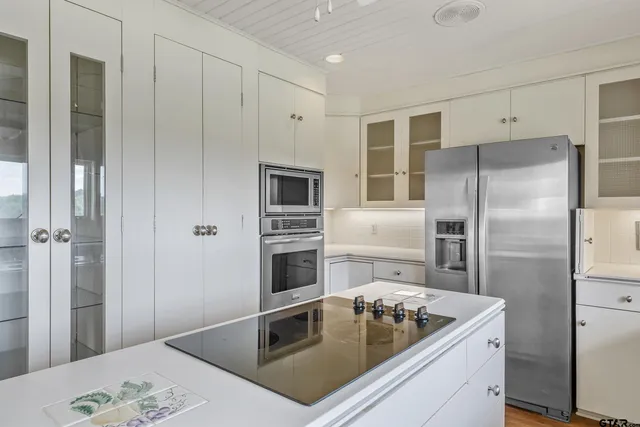 a view white cabinets and sink