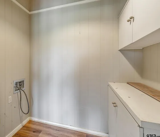 a view of a room with wooden floor and windows