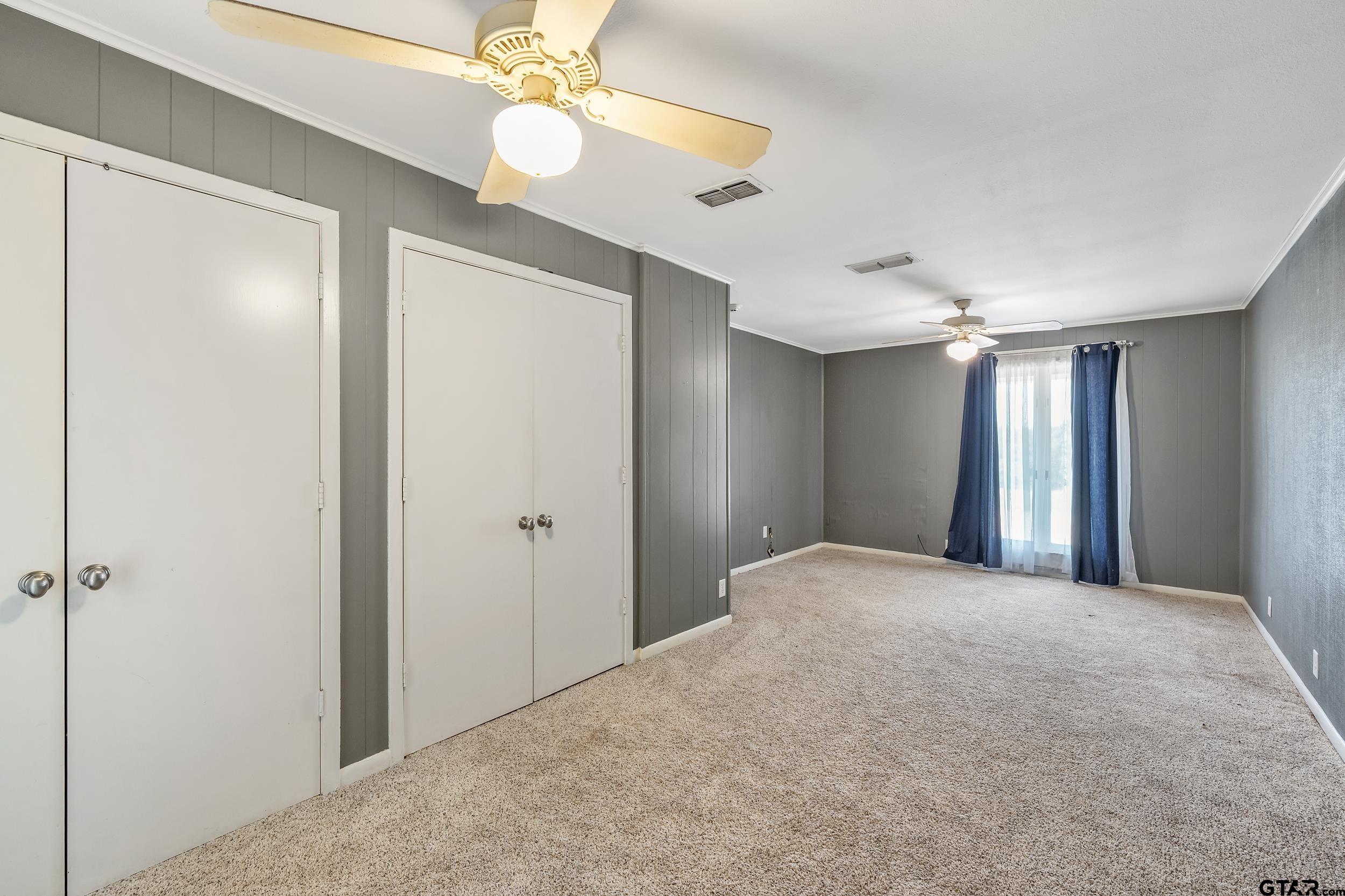 17823 County Road 132 Flint, TX 75762 - Photo 30 of 48 a view of a bedroom with closet and a ceiling fan