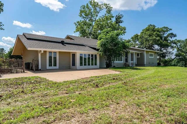 a view of a backyard with a large tree