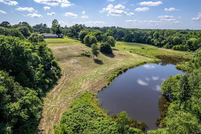 an aerial view of a house with a lake view
