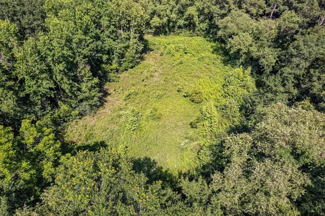an aerial view of residential house with outdoor space and swimming pool