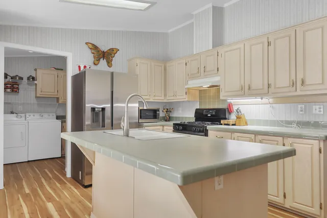 a kitchen with stainless steel appliances granite countertop a sink and cabinets