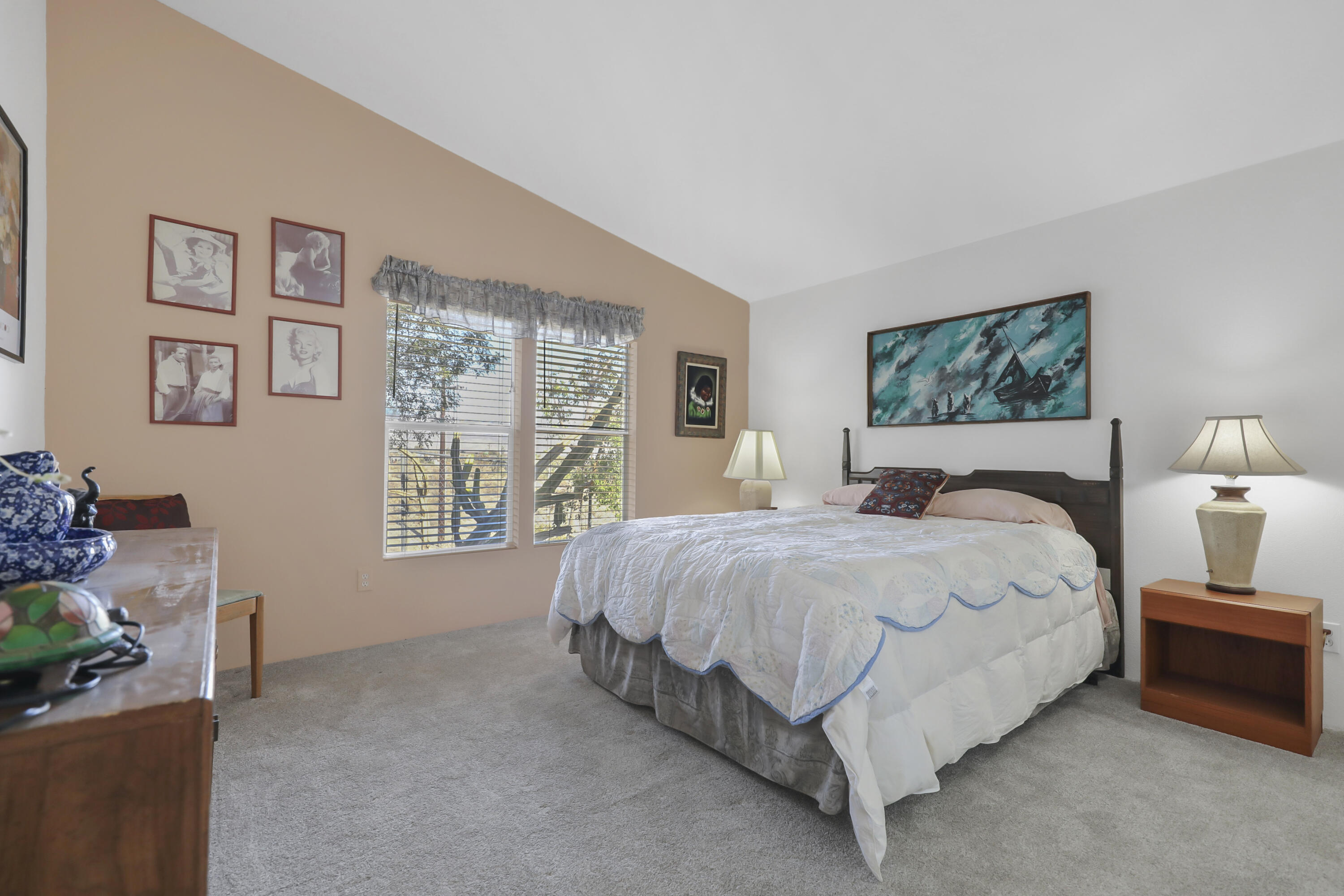 60781 Painted Hills Road Whitewater, CA 92282 - Photo 29 of 39 a large bed sitting in a bedroom next to a window with a lamp and a large window