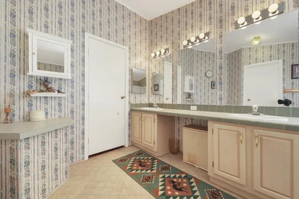 a bathroom with a sink a mirror and a shower