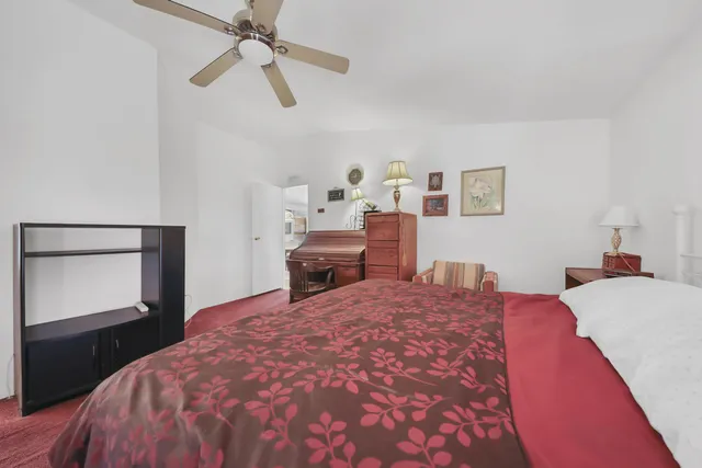 a bedroom with a bed and a dresser