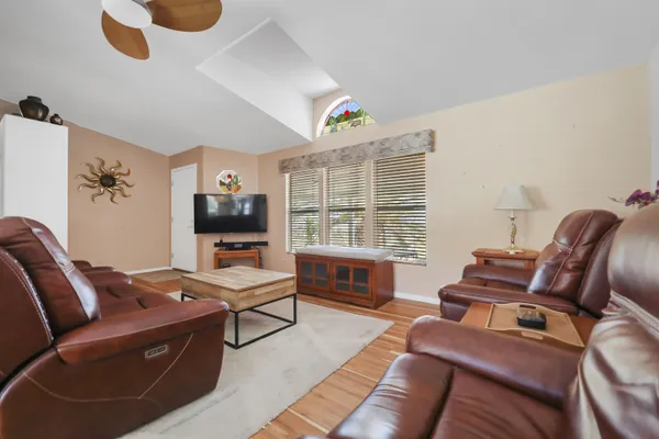 a bedroom with furniture and a flat screen tv