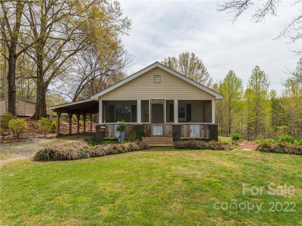 4467 Big Level Road Mill Spring, NC 28756 - Photo 1 of 33 a front view of a house with a garden