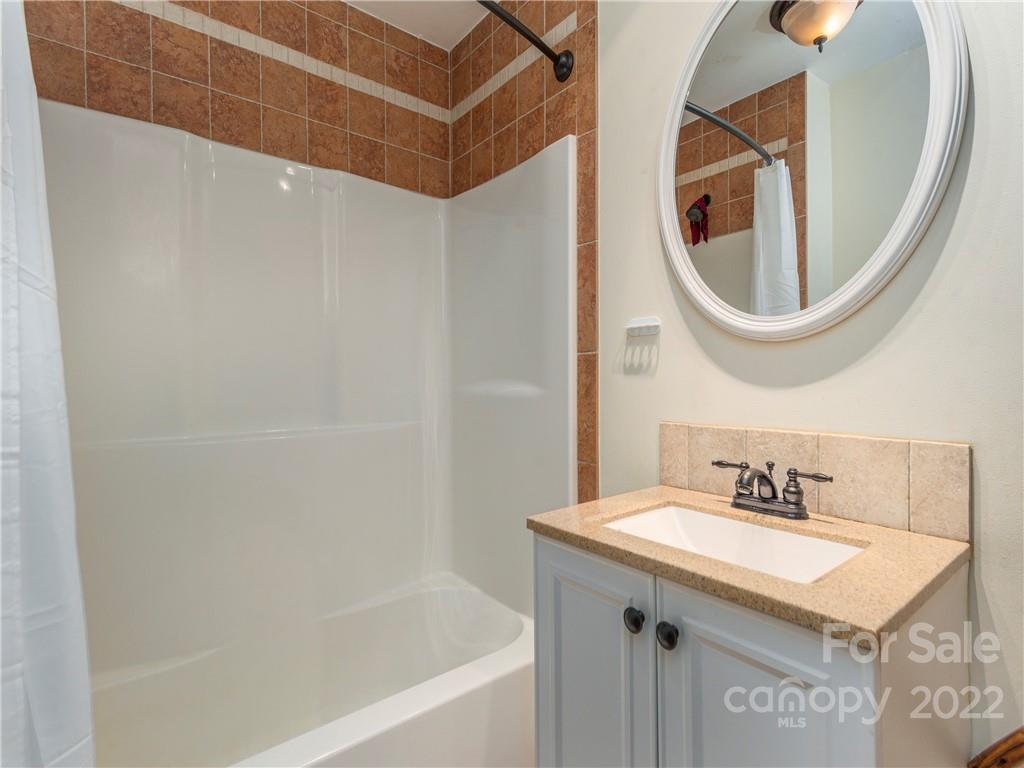 4467 Big Level Road Mill Spring, NC 28756 - Photo 11 of 33 a bathroom with a sink and a mirror