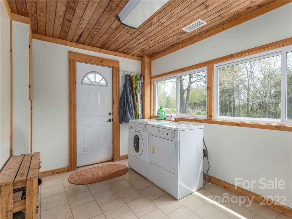 4467 Big Level Road Mill Spring, NC 28756 - Photo 12 of 33 a spacious bathroom with a granite countertop sink and washing machine