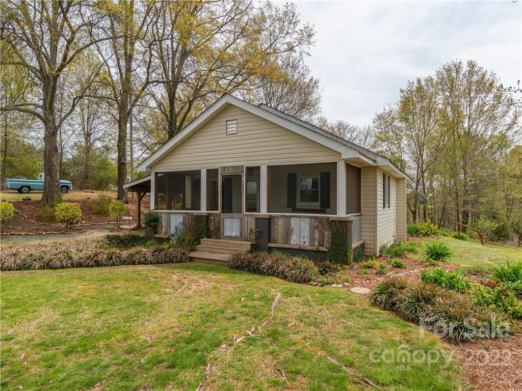 4467 Big Level Road Mill Spring, NC 28756 - Photo 14 of 33 a front view of a house with a garden