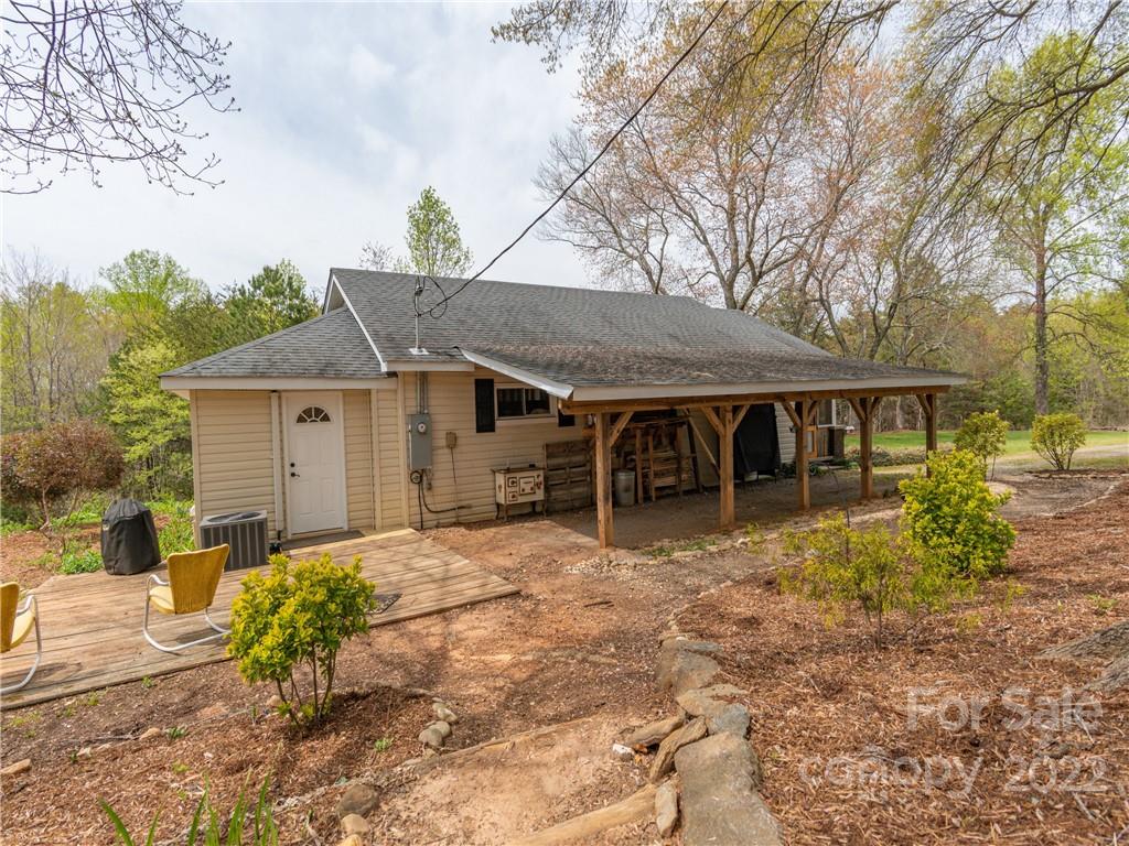 4467 Big Level Road Mill Spring, NC 28756 - Photo 16 of 33 a front view of a house with a yard outdoor seating and garage