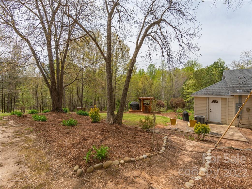 4467 Big Level Road Mill Spring, NC 28756 - Photo 17 of 33 a view of a backyard with large trees
