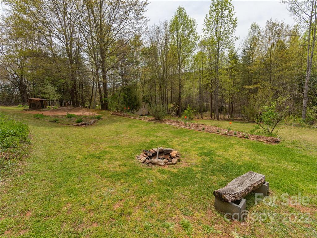 4467 Big Level Road Mill Spring, NC 28756 - Photo 20 of 33 a backyard of a house with table and chairs