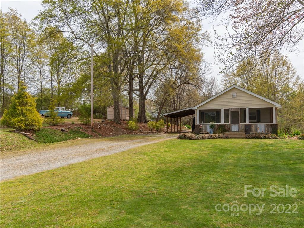 4467 Big Level Road Mill Spring, NC 28756 - Photo 2 of 33 a front view of a house with yard and green space