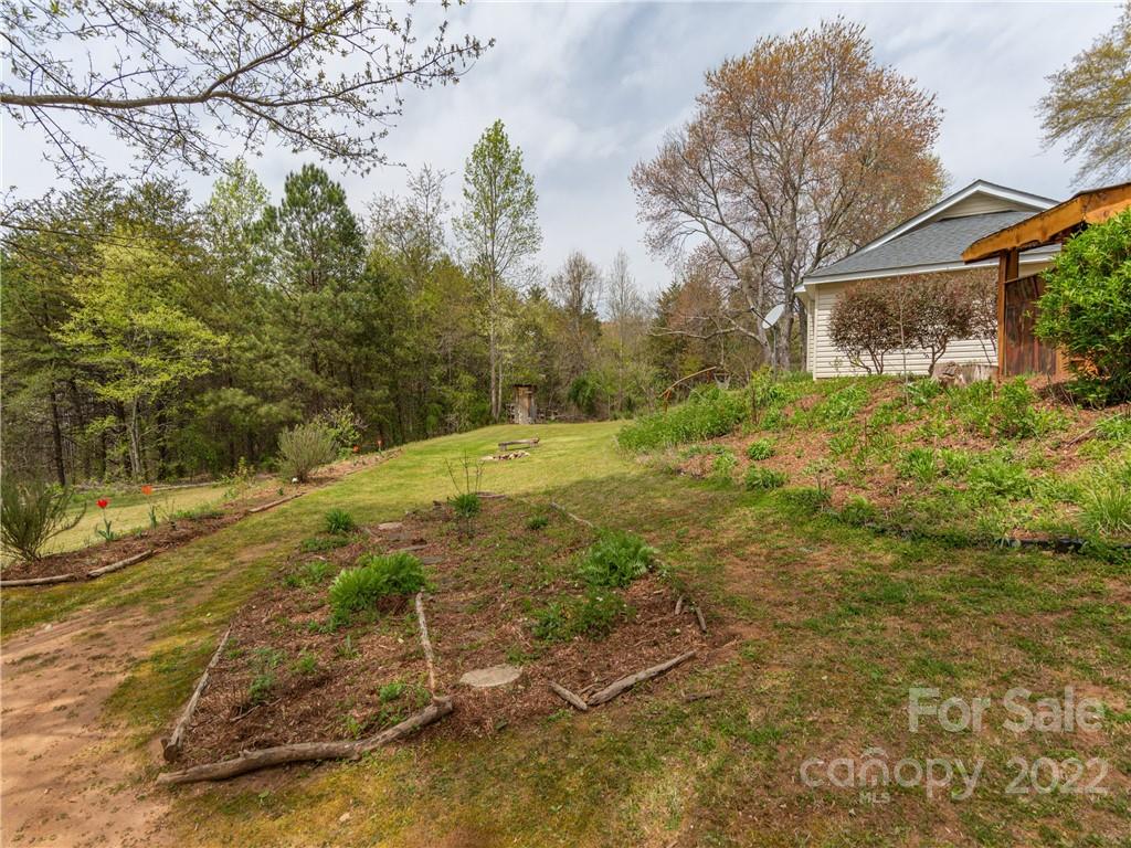 4467 Big Level Road Mill Spring, NC 28756 - Photo 25 of 33 a backyard of a house with lots of green space