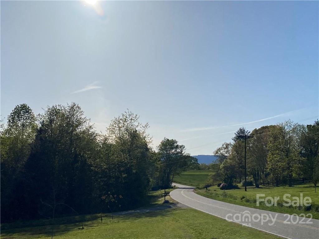 4467 Big Level Road Mill Spring, NC 28756 - Photo 32 of 33 a view of a grassy area with an trees