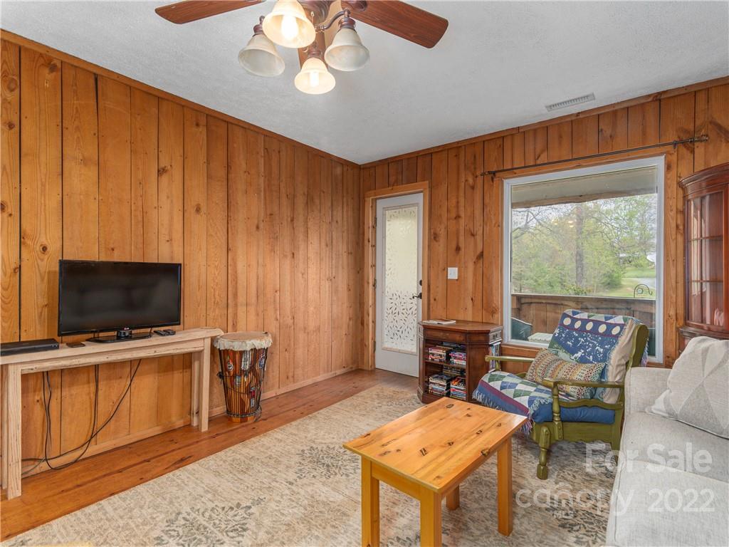 4467 Big Level Road Mill Spring, NC 28756 - Photo 5 of 33 a living room with furniture a flat screen tv and a window