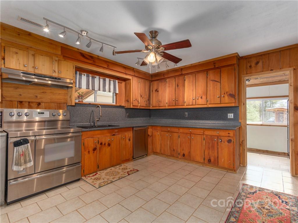4467 Big Level Road Mill Spring, NC 28756 - Photo 6 of 33 a kitchen with stainless steel appliances granite countertop a sink and cabinets