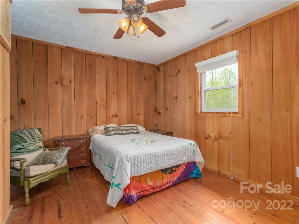 4467 Big Level Road Mill Spring, NC 28756 - Photo 8 of 33 a bedroom with a bed and a window