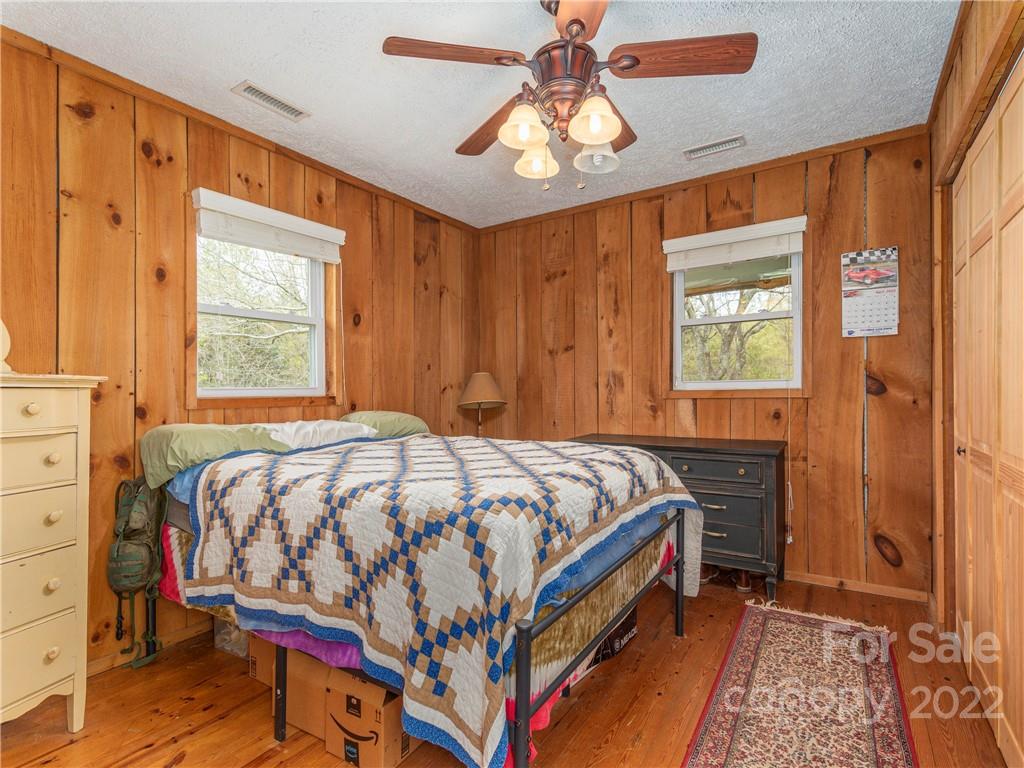 4467 Big Level Road Mill Spring, NC 28756 - Photo 9 of 33 a bedroom with a bed and a window