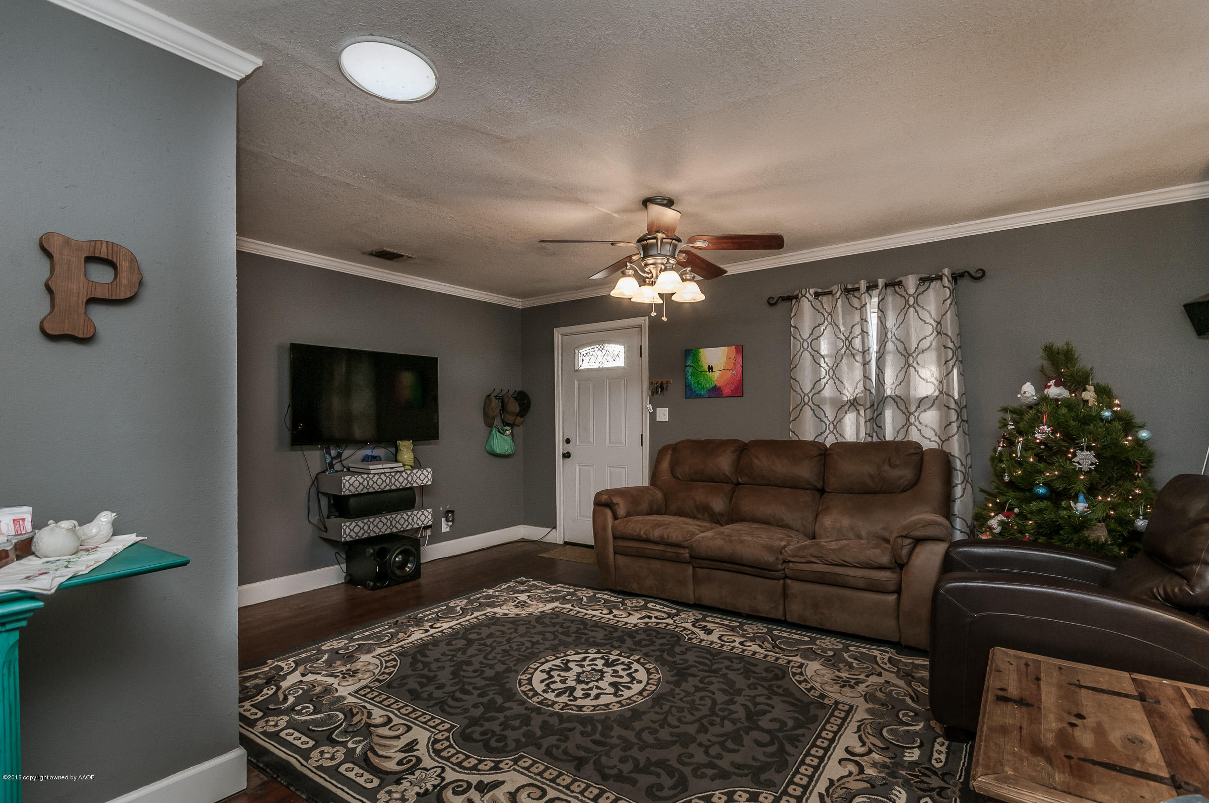 3807 Gables Street Amarillo, TX 79110 - Photo 3 of 16 a living room with furniture and a flat screen tv
