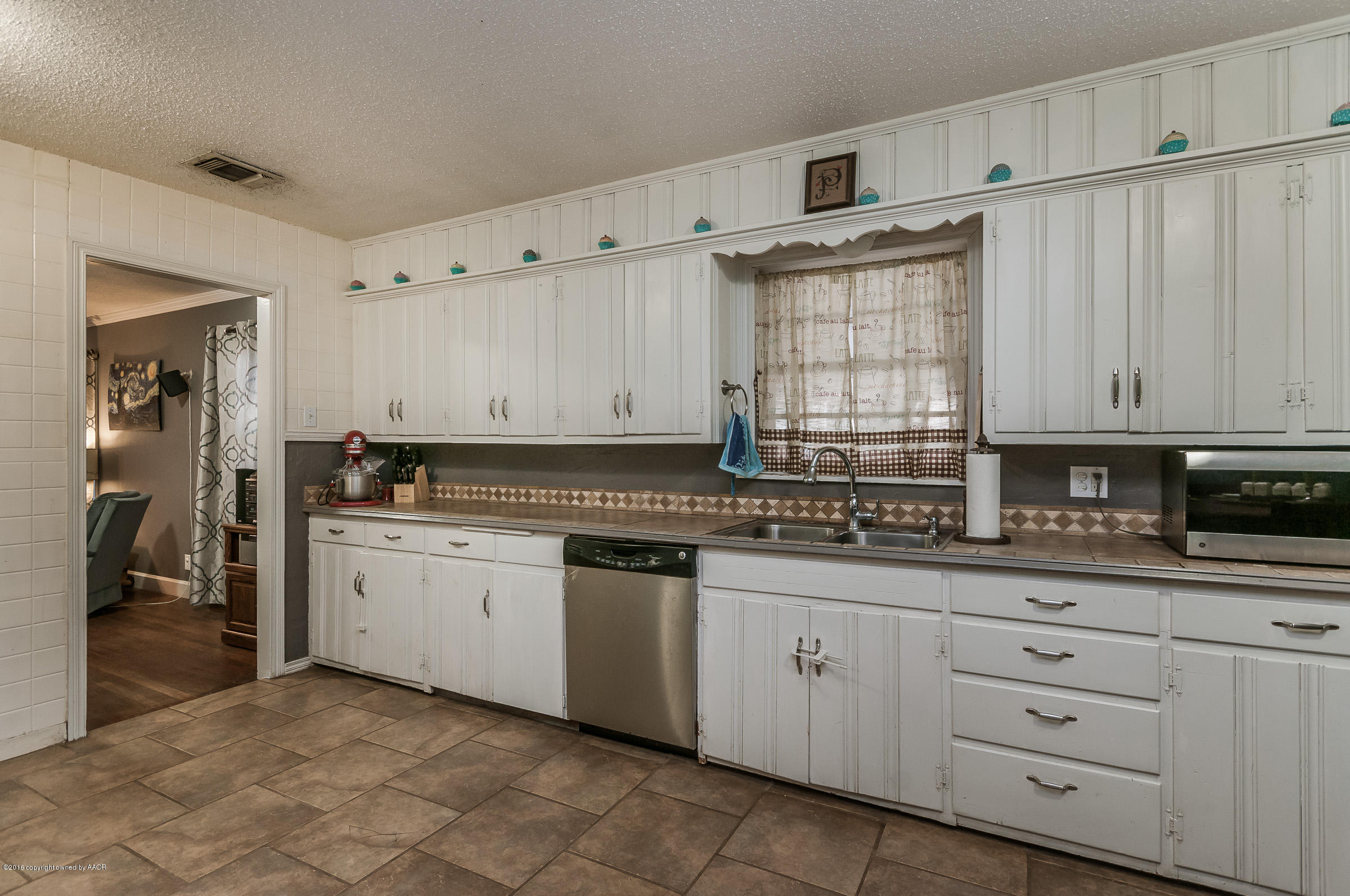 3807 Gables Street Amarillo, TX 79110 - Photo 5 of 16 a kitchen with granite countertop white cabinets and white appliances