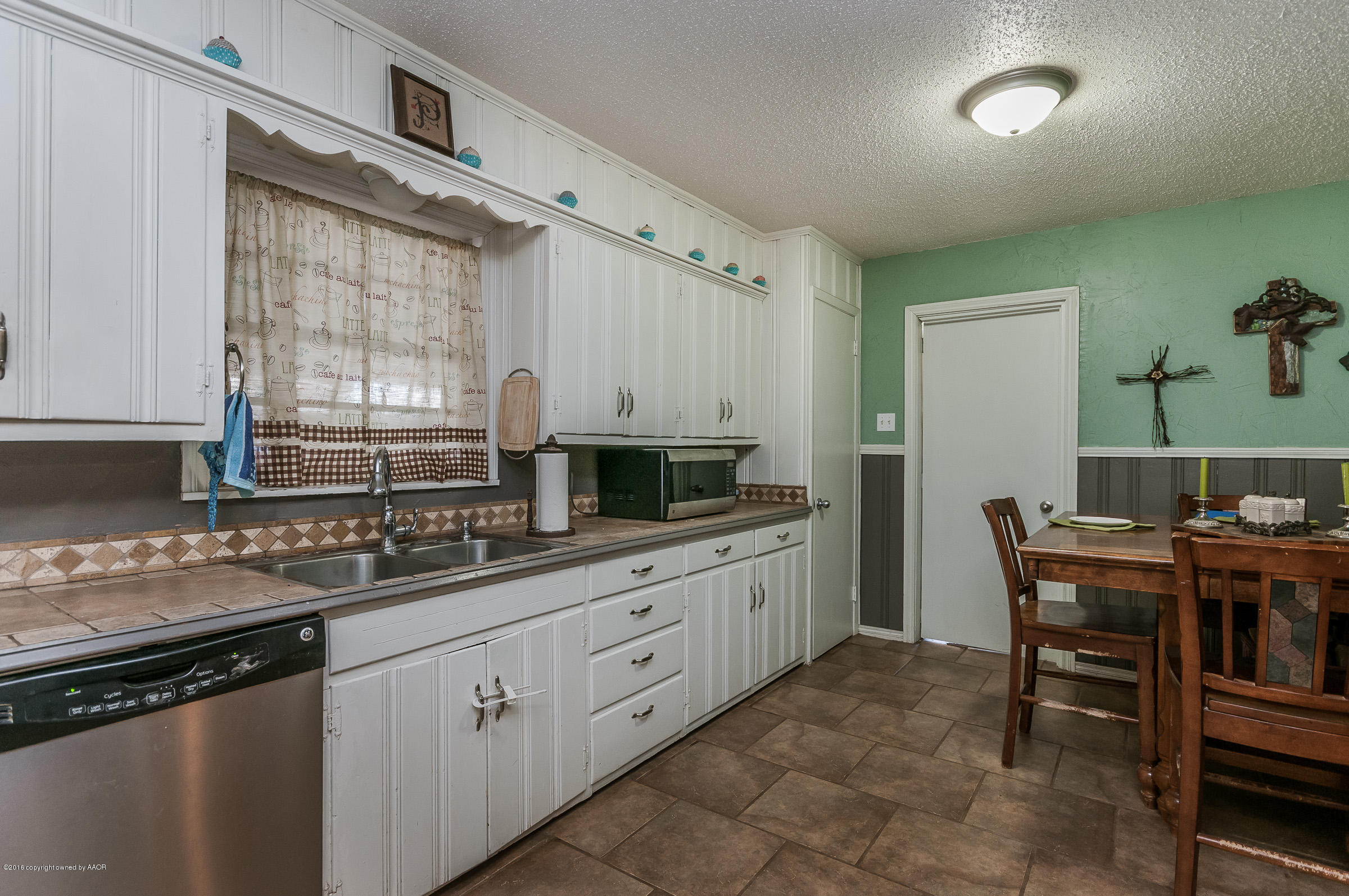 3807 Gables Street Amarillo, TX 79110 - Photo 6 of 16 a kitchen that has a sink and a stove in it