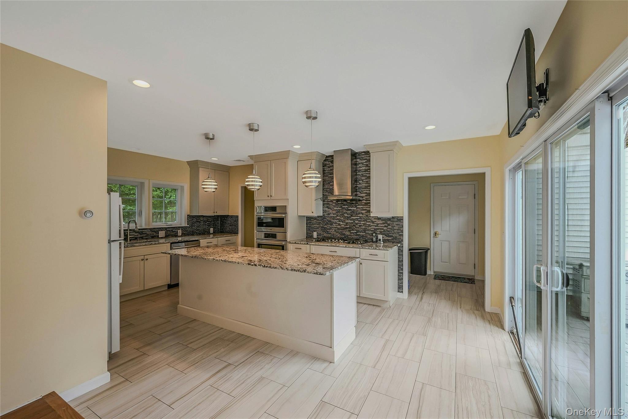 144 S Path Calverton, NY 11933 - Photo 11 of 19 a kitchen with stainless steel appliances a refrigerator and a stove top oven