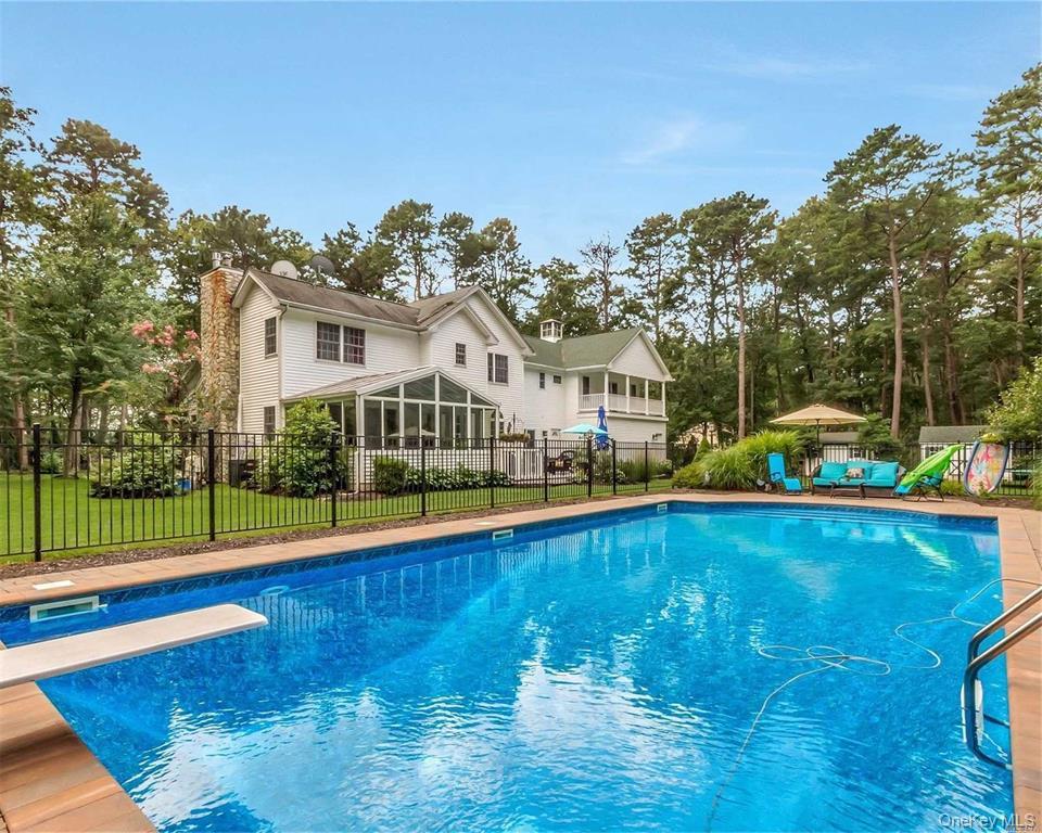 144 S Path Calverton, NY 11933 - Photo 7 of 19 a view of a house with pool and a yard with lawn chairs