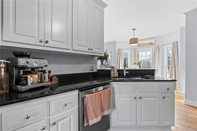 a view of a dining room with furniture and a chandelier