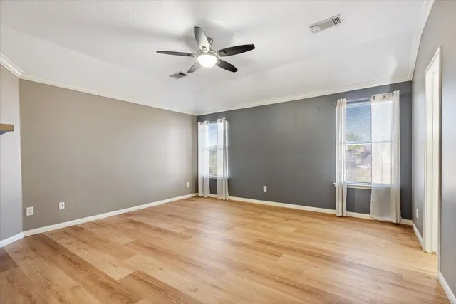 wooden floor in an empty room with a window