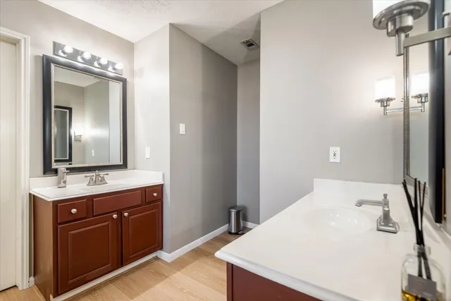 a bathroom with a shower sink vanity and mirror