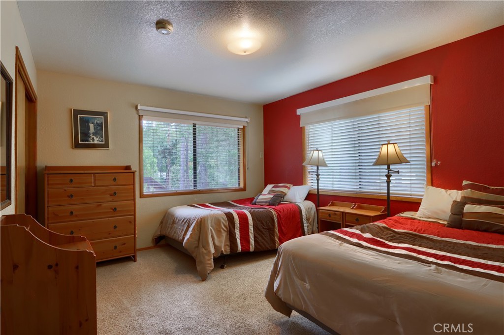 8041 Chilnualna Falls Road Wawona, CA 95389 - Photo 17 of 46 a bedroom with two beds and a window