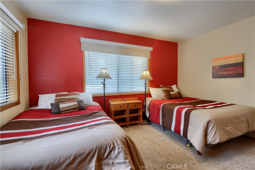 8041 Chilnualna Falls Road Wawona, CA 95389 - Photo 18 of 46 a bedroom with two beds and a window
