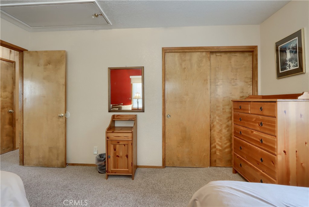 8041 Chilnualna Falls Road Wawona, CA 95389 - Photo 19 of 46 a bedroom with a bed and furniture