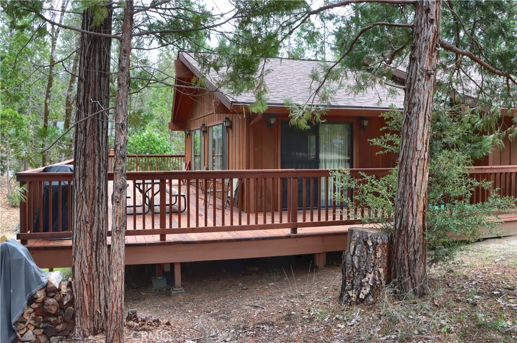 8041 Chilnualna Falls Road Wawona, CA 95389 - Photo 2 of 46 a view of a wooden house with a yard and furniture