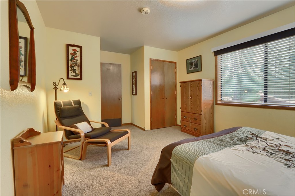 8041 Chilnualna Falls Road Wawona, CA 95389 - Photo 21 of 46 a bedroom with a bed and furniture