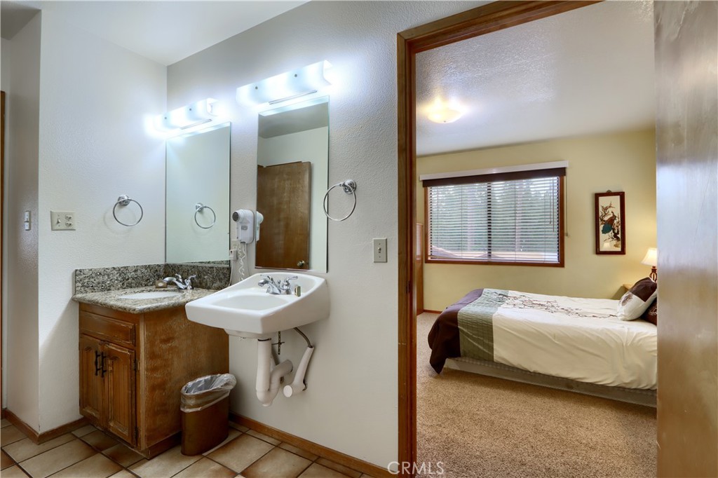 8041 Chilnualna Falls Road Wawona, CA 95389 - Photo 23 of 46 a bedroom with a bed and a mirror